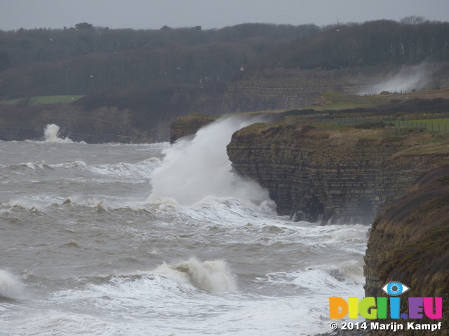 LZ00560 Waves crashing against cliffs at Llantwit Major beach